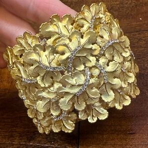 Roberto for RFM clear crystals accentuating a leaf design hinged bangle bracelet